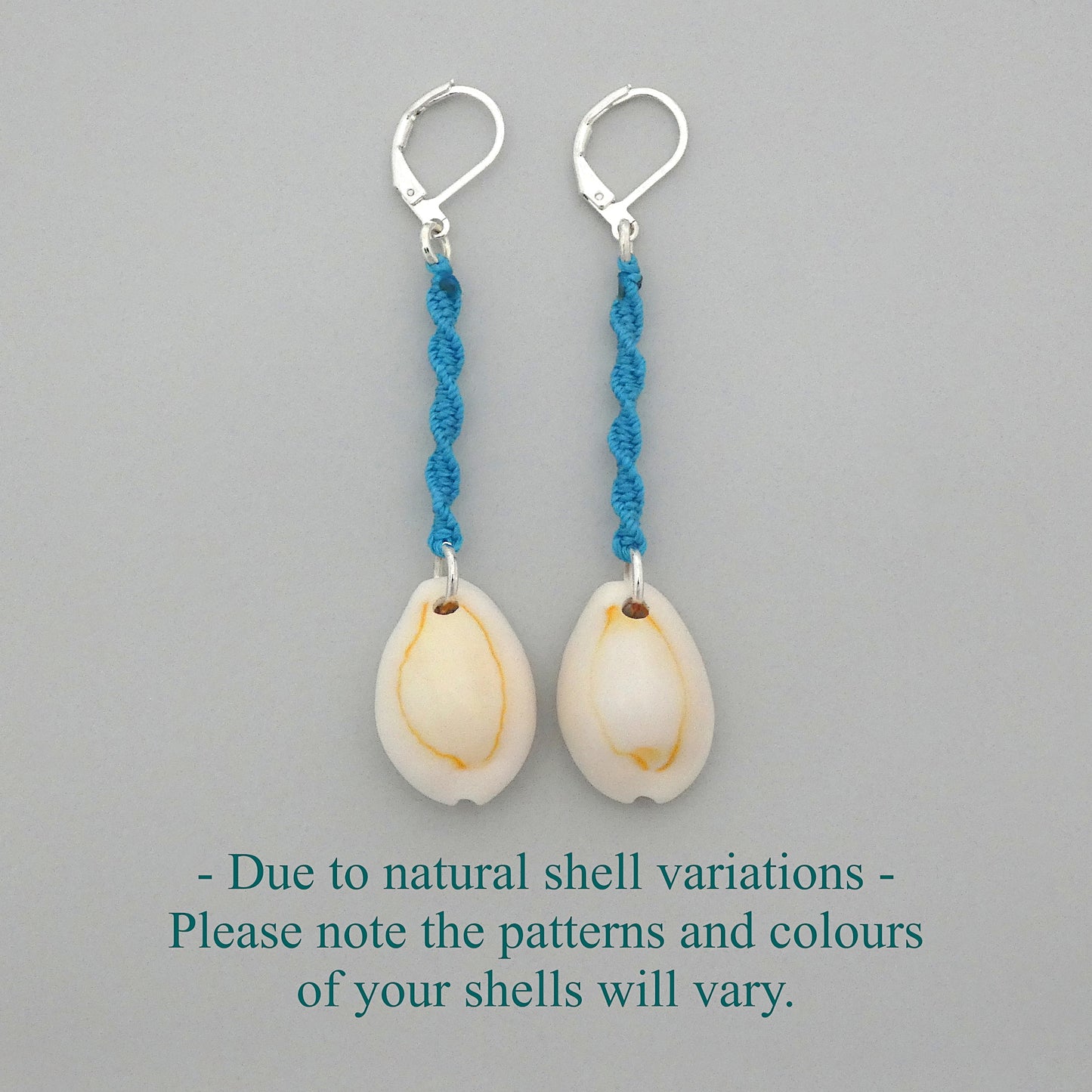 Silver plated leverback earrings with cowrie shells and blue macramé twist detail.