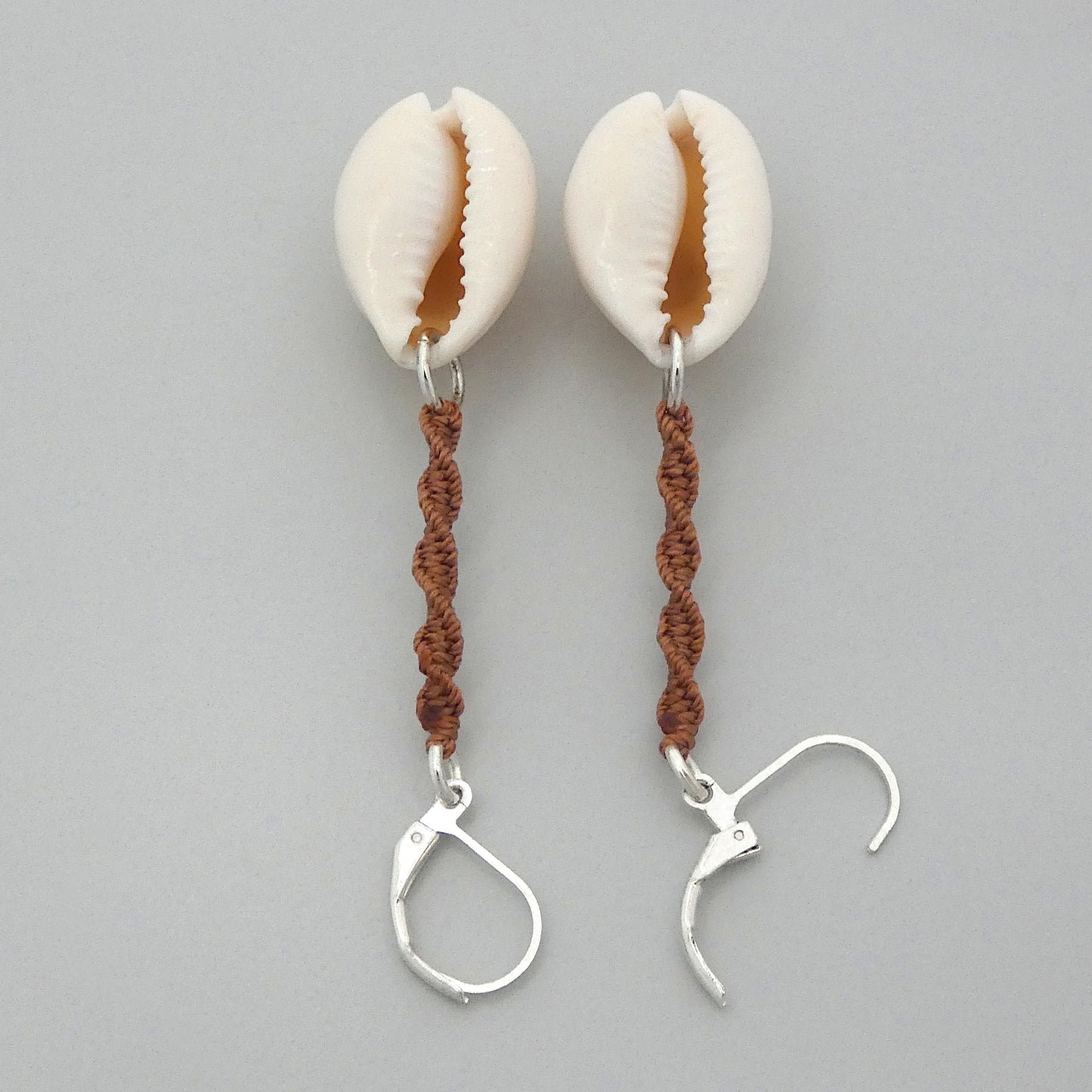 Silver plated leverback earrings with cowrie shells and copper coloured macramé twist detail.