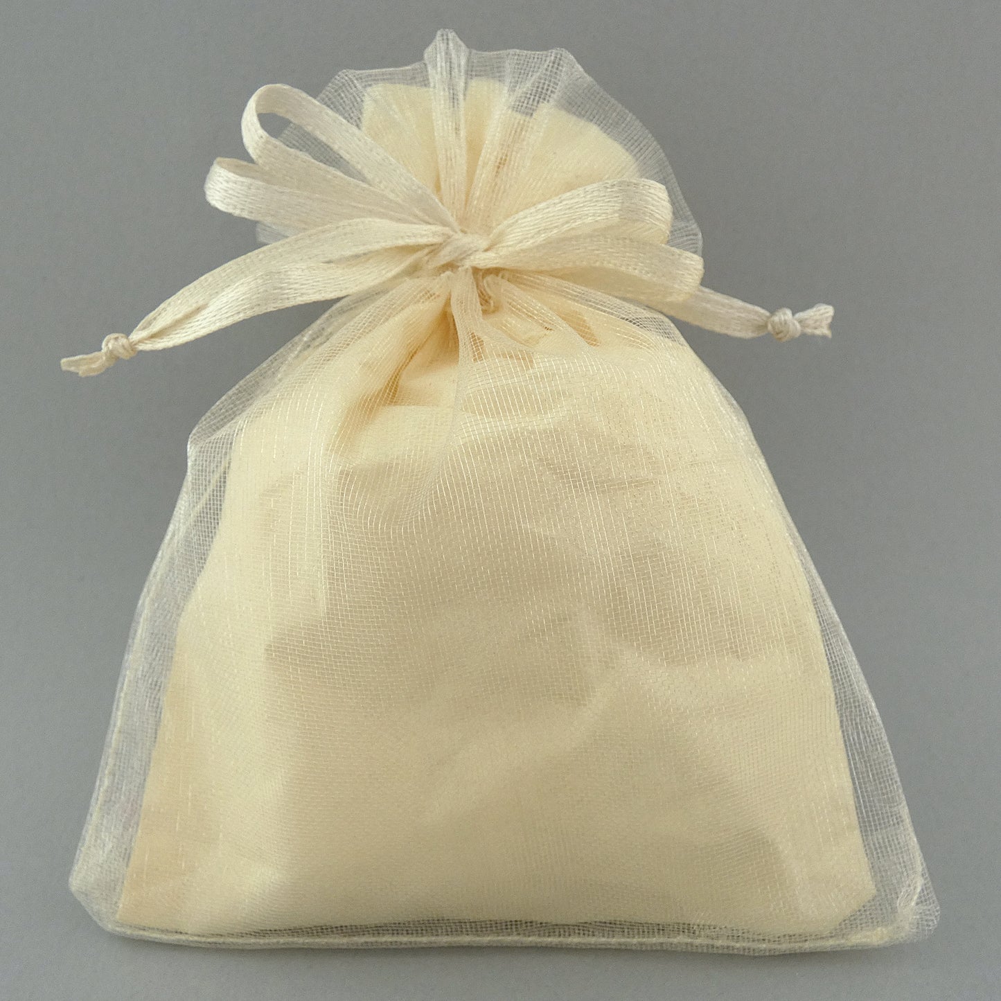 cream organza bag with matching tissue paper inside.