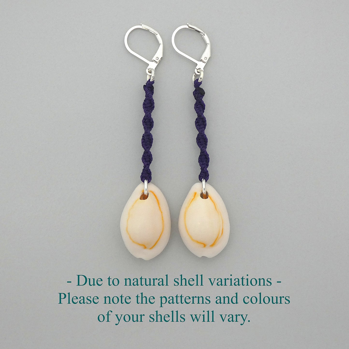 Silver plated leverback earrings with cowrie shells and dark purple macramé twist detail.