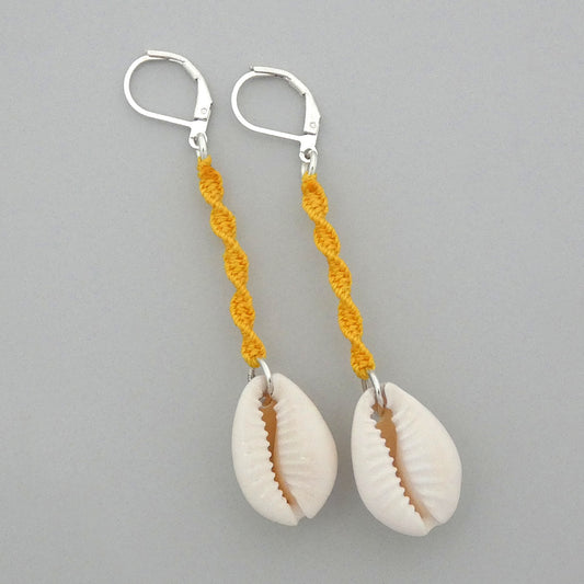 Silver plated leverback earrings with cowrie shells and golden yellow macramé twist detail.