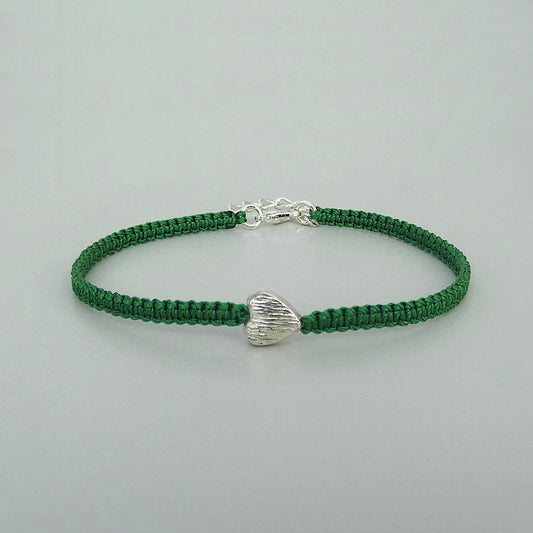 Christmas green seven inch macramé bracelet with silver plated textured heart charm, lobster clasp and one inch extender chain.