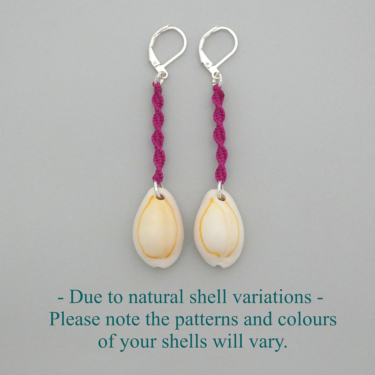 Silver plated leverback earrings with cowrie shells and magenta macramé twist detail.