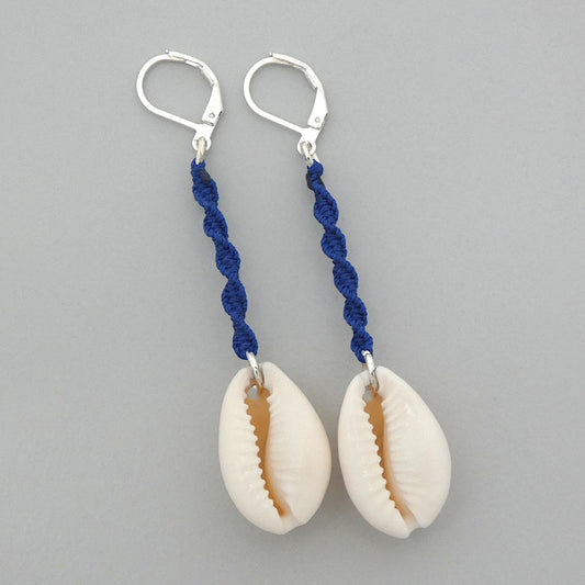 Silver plated leverback earrings with cowrie shells and royal blue macramé twist detail.