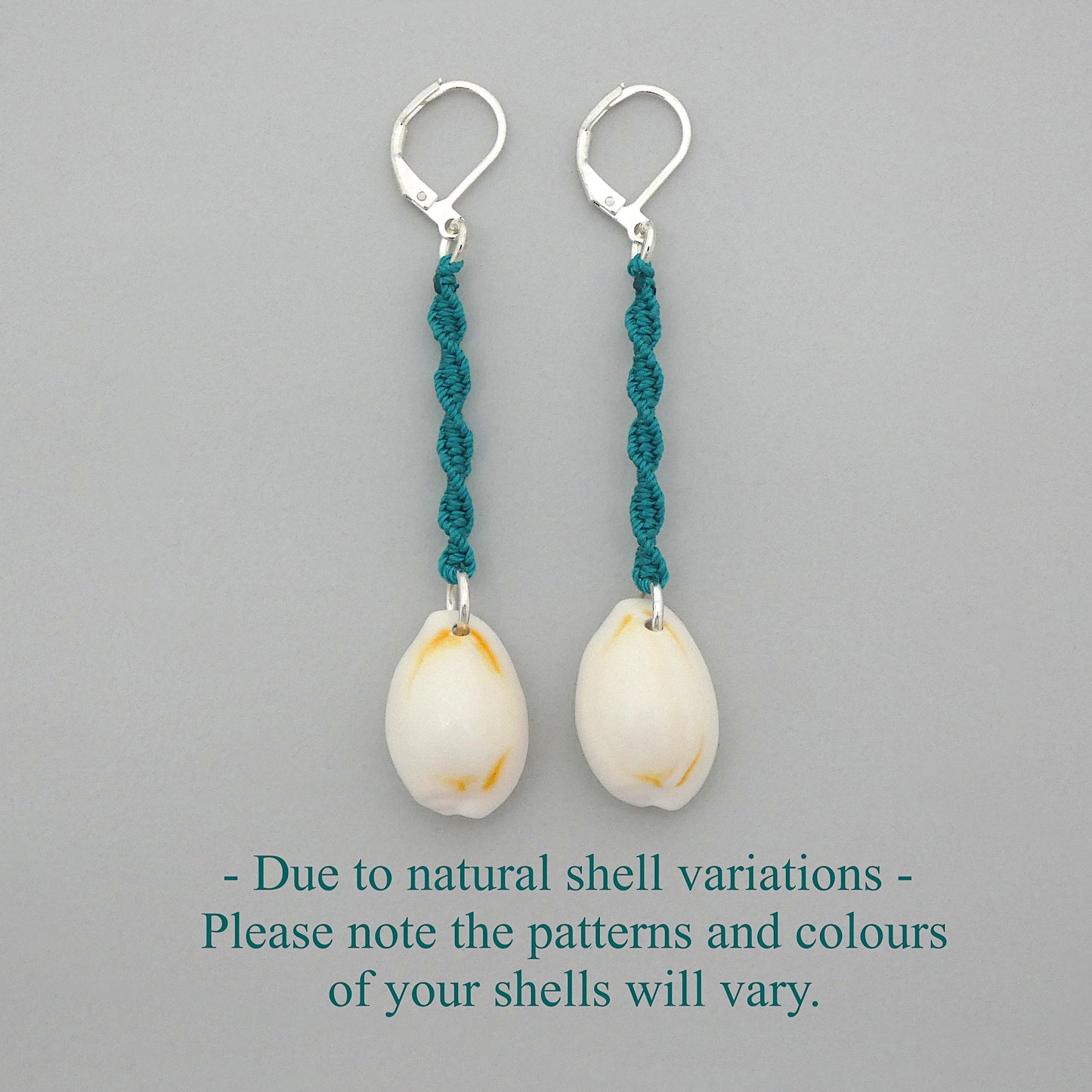 Silver plated leverback earrings with cowrie shells and teal green macramé twist detail.