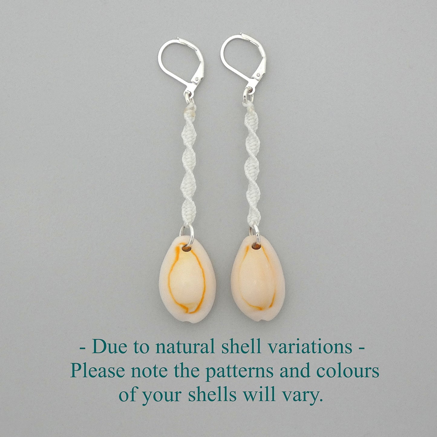 Silver plated leverback earrings with cowrie shells and white macramé twist detail.